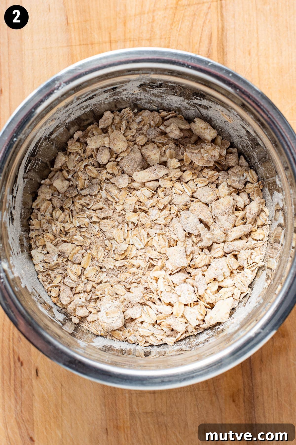 Skillet Apple Crisp Recipe with Cinnamon Oat Topping 4 Brown sugar, flour, oats, and butter mixed together in a small stainless steel bowl.