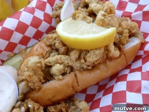 Ordering Lobster Rolls on Weight Watchers at The Lobster Lady 3 Fried Clam Roll in hot dog bun with lemon wedge.