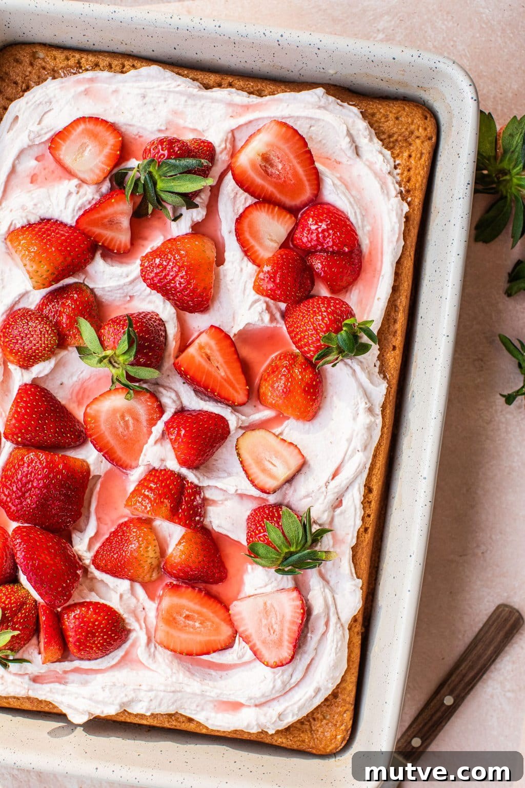 Strawberry Tres Leches Cake Recipe 9 strawberry tres leches cake with light pink icing and fresh strawberries on the top