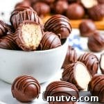 Peanut butter balls stacked in a white glass bowl