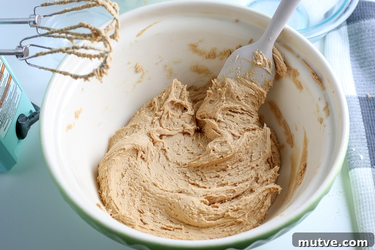 Old Fashioned No Bake Peanut Butter Balls Recipe 6 peanut butter balls mixture in a mixing bowl.