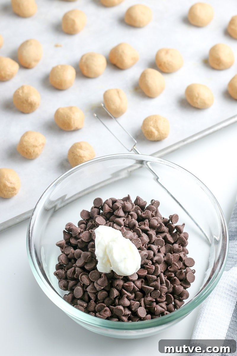 Old Fashioned No Bake Peanut Butter Balls Recipe 7 chocolate chips and vegetable oil in a small glass bowl and peanut butter balls on a baking sheet with parchment paper.