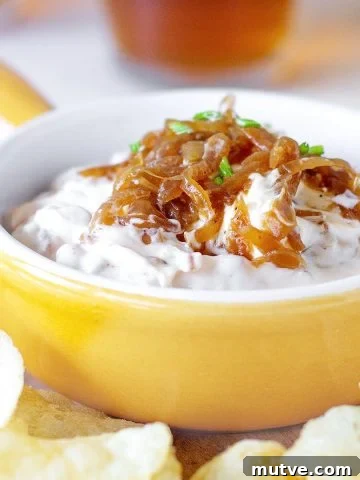 Yellow shallow ramekin with caramelized Onion Dip surrounded by potato chips