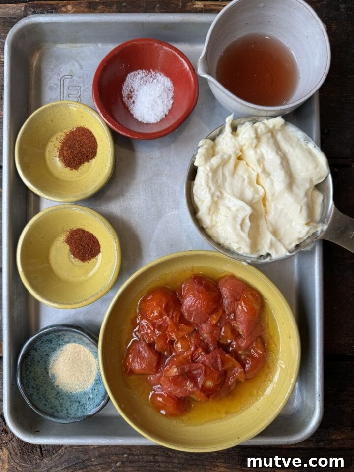 Fresh ingredients for homemade salsa on a metal tray, including tomatoes, spices, and condiments.