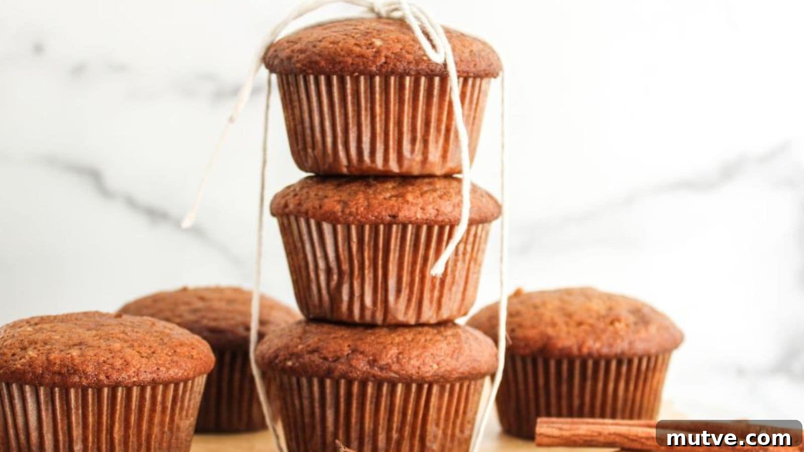 A stack of pumpkin spiced muffins on a plate.