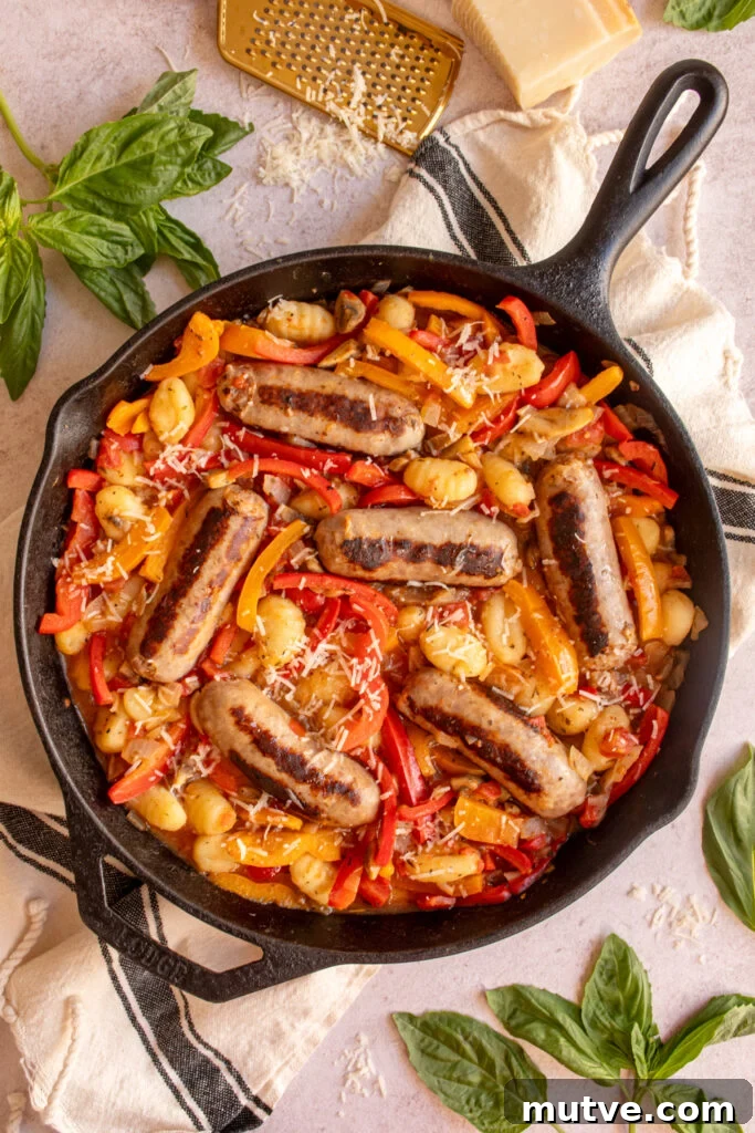 Skillet Gnocchi with Italian Sausage and Peppers 2 A large cast iron skillet filled with colorful bell peppers, gnocchi, and italian sausages.