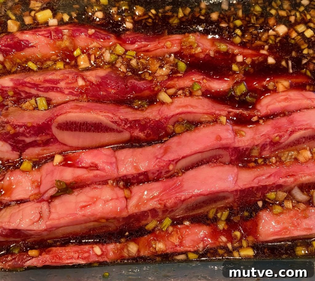 Adding beef ribs into marinade bowl.