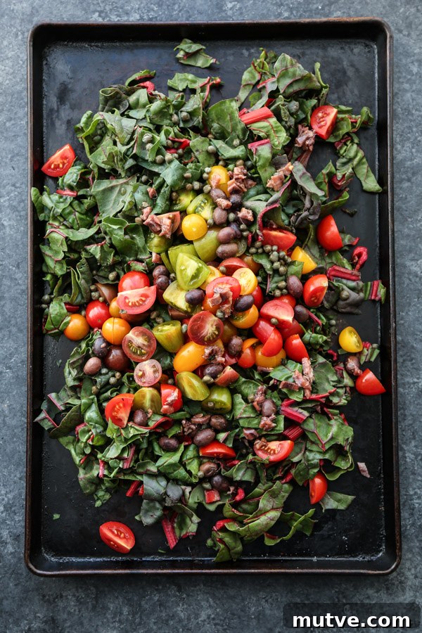 Sheet Pan Shrimp Puttanesca with Chard and Cherry Tomatoes 3 Cherry tomatoes, olives and chard on a sheet pan
