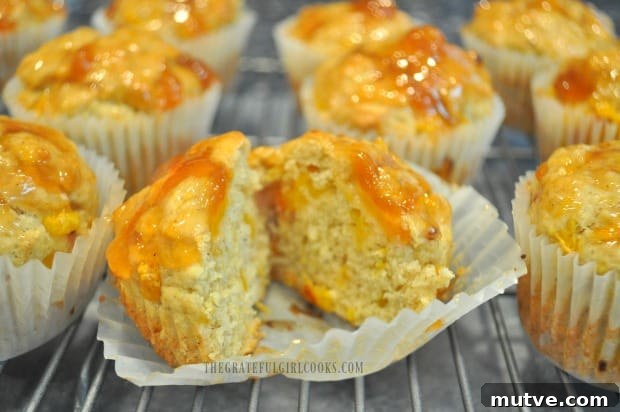Peach Jam Muffins -The Grateful Girl Cooks! An inside look at a cut open peach jam muffin.