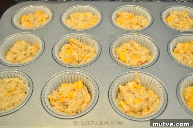 Peach Jam Muffins -The Grateful Girl Cooks! Batter for peach jam muffins is added to muffin tin for baking.