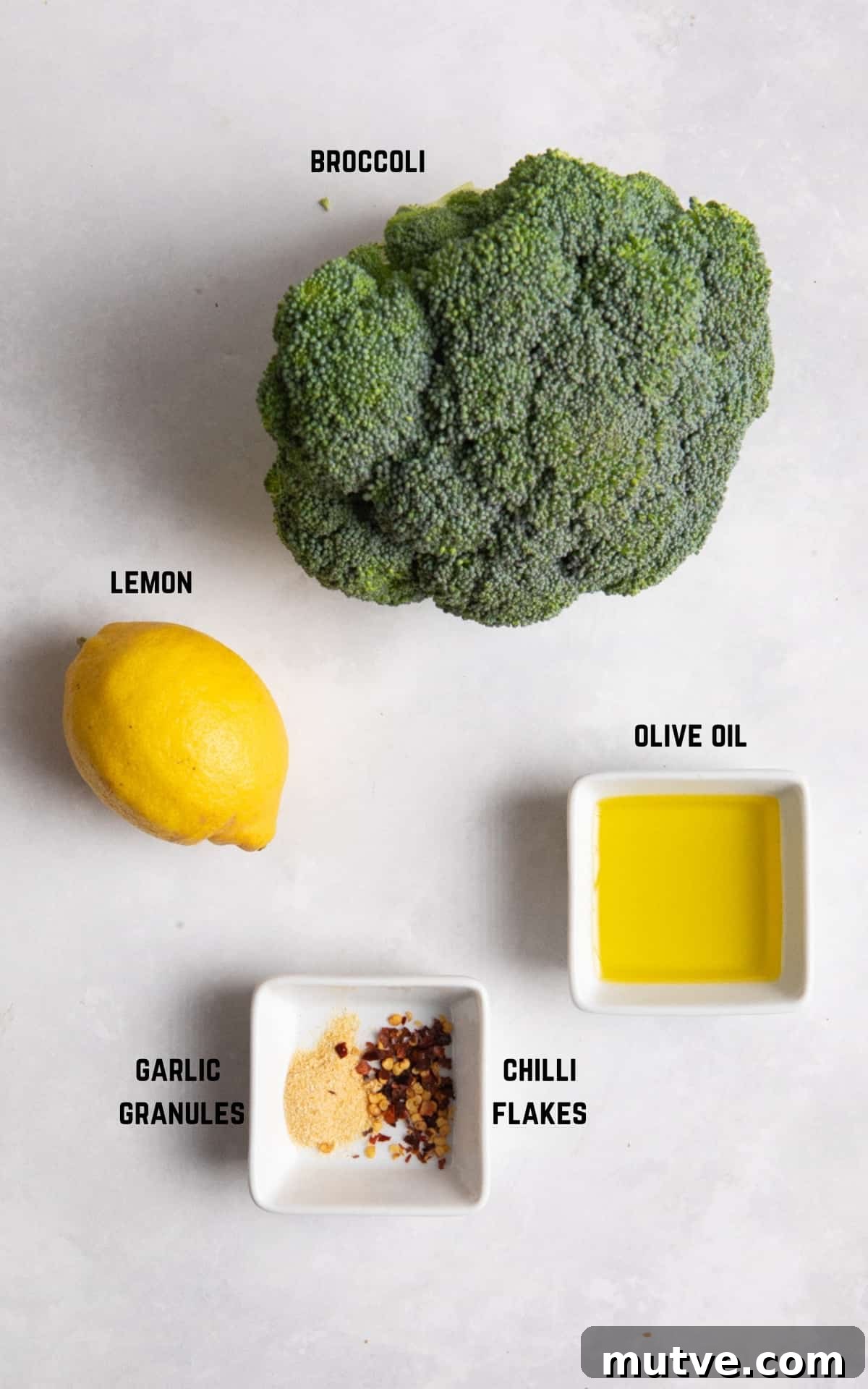 Crispy Air Fryer Broccoli in 10 Minutes 3 Ingredients to make air fryer broccoli on white surface.