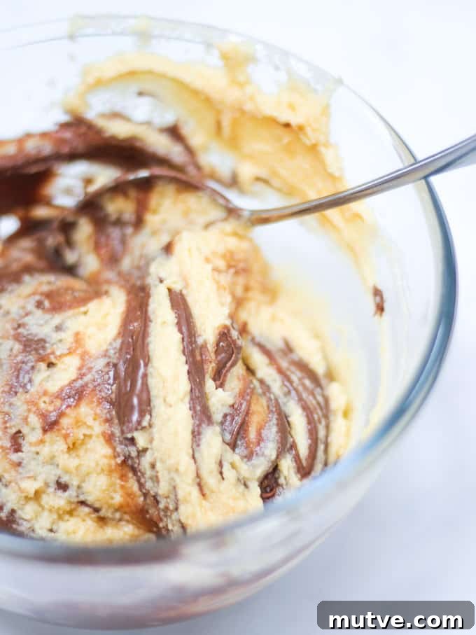 Quick Nutella Cake Recipe: Moist Chocolate Hazelnut Cake 4 Marble cake mixture raw in glass bowl of Nutella Cake.