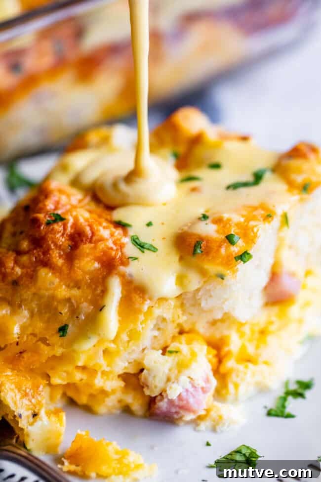 Cheesy Biscuit-Topped Breakfast Casserole Recipe 2 breakfast casserole with biscuits, hollandaise sauce drizzling on top.