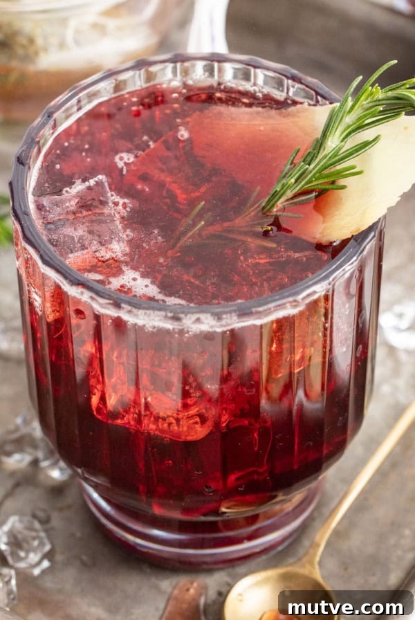 A sleepy girl mocktail on a tray with a small gold spoon.