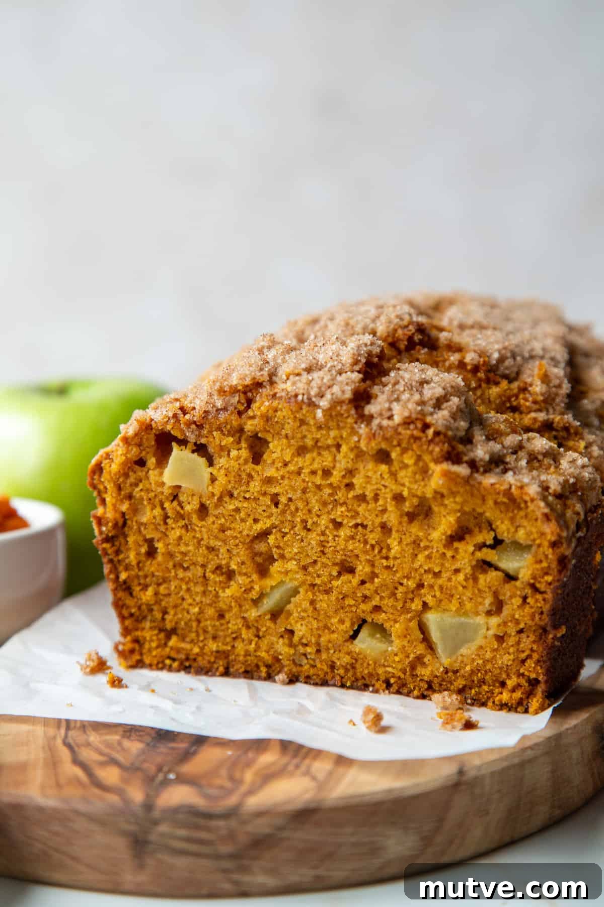 Cinnamon-Spiced Pumpkin Apple Bread 2 pumpkin apple bread sliced on a wooden board.