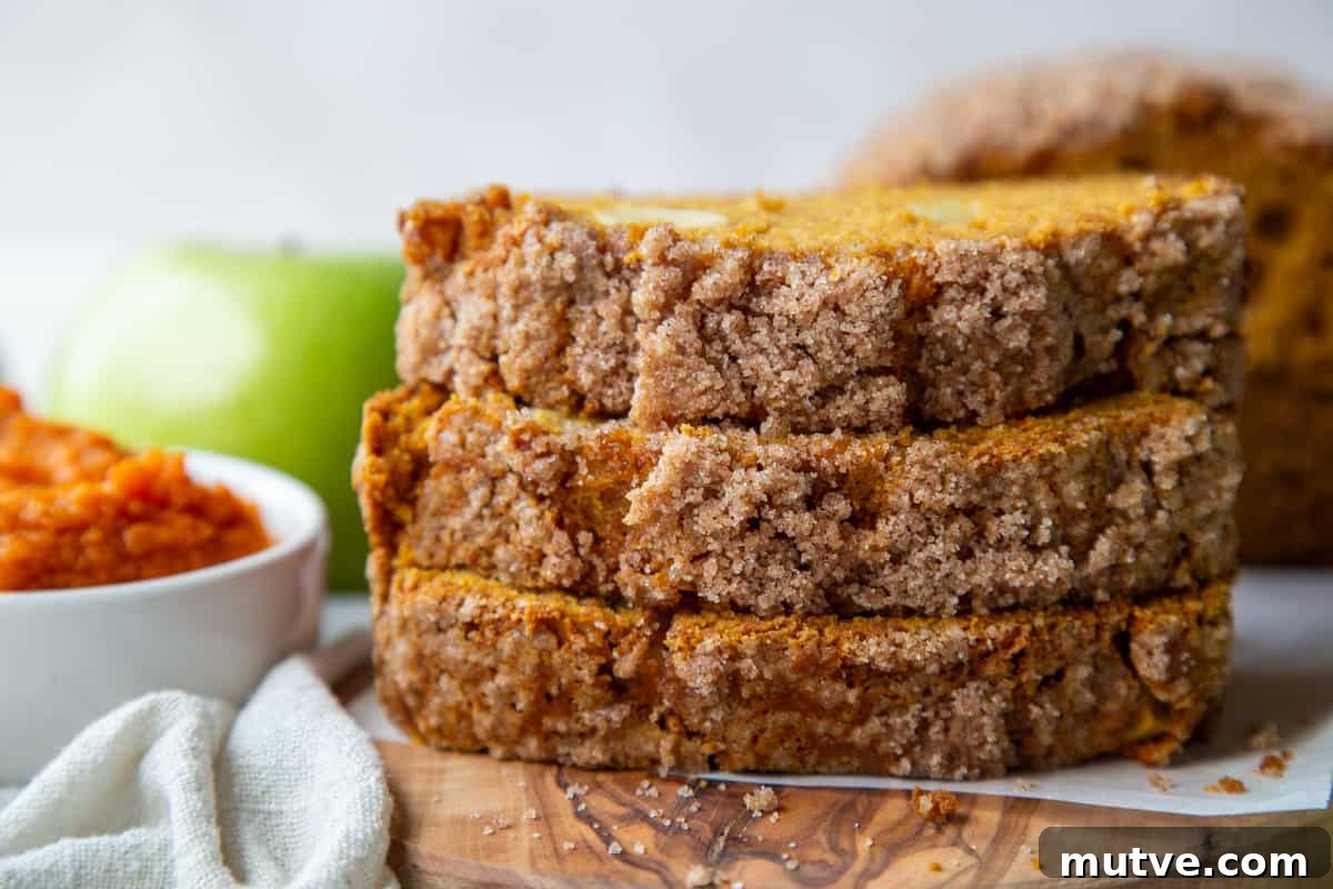Cinnamon-Spiced Pumpkin Apple Bread 3 three slices of pumpkin apple bread stacked.
