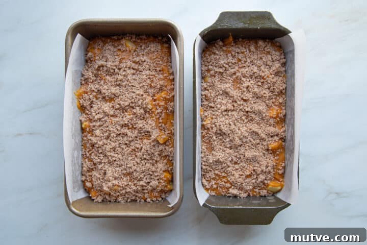 Cinnamon-Spiced Pumpkin Apple Bread 8 unbaked pumpkin bread in loaf pans, topped with streusel.