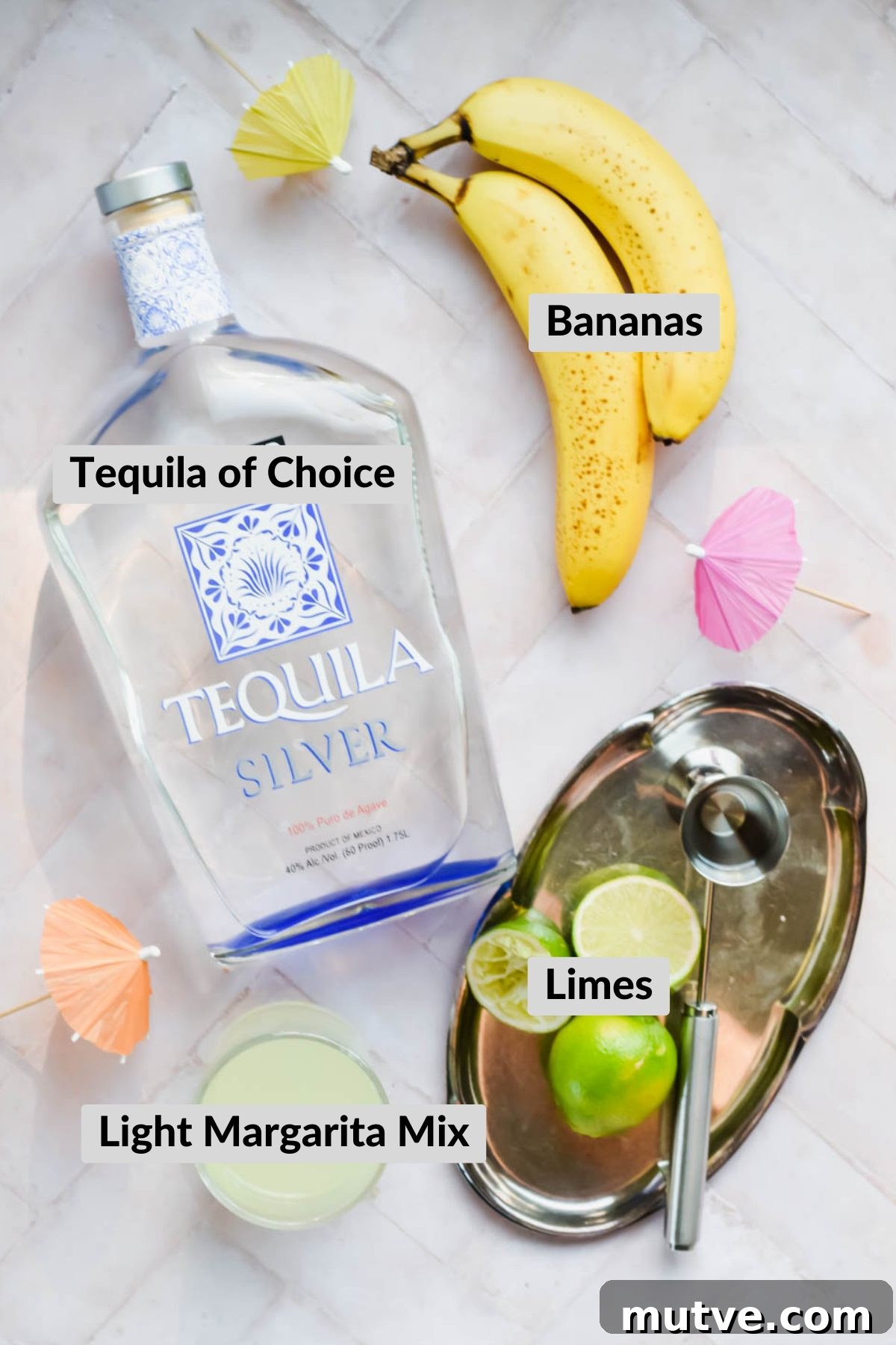 Banana Margarita Recipe: Creamy Tropical Cocktail 3 ingredients for banana margarita spread on white background.