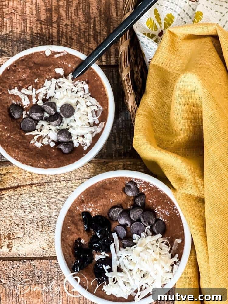 Two ramekins of Mexican chocolate chia pudding topped with coconut flakes and chocolate chips