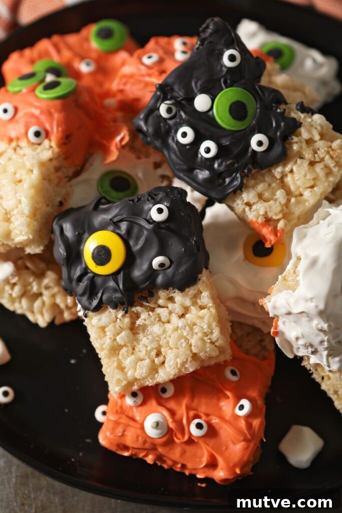 Decorate Monster Halloween Rice Krispie Treats on a black plate