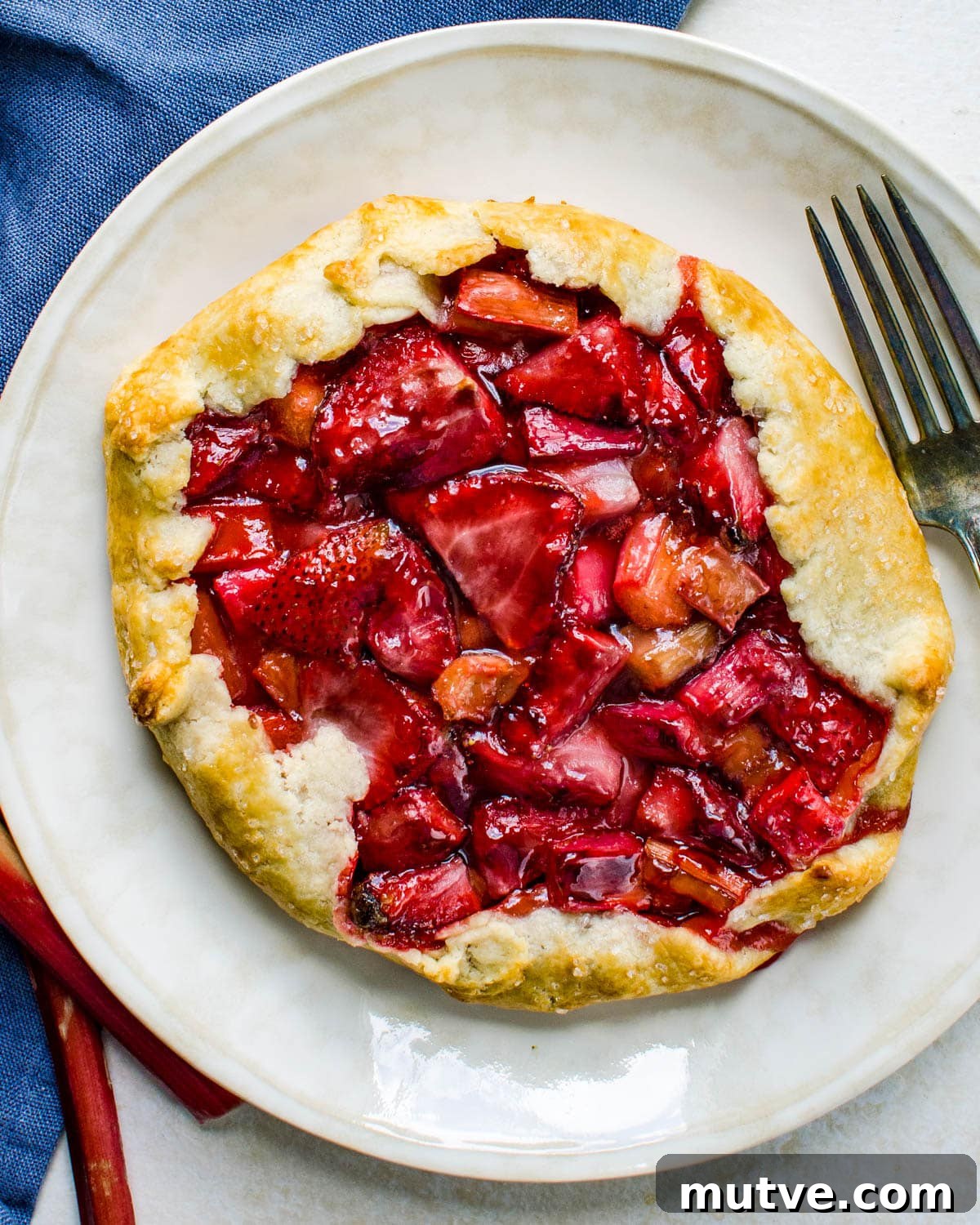 Rustic Strawberry Rhubarb Galette with Flaky Crust 14 Serving a portion of the galette on a plate.