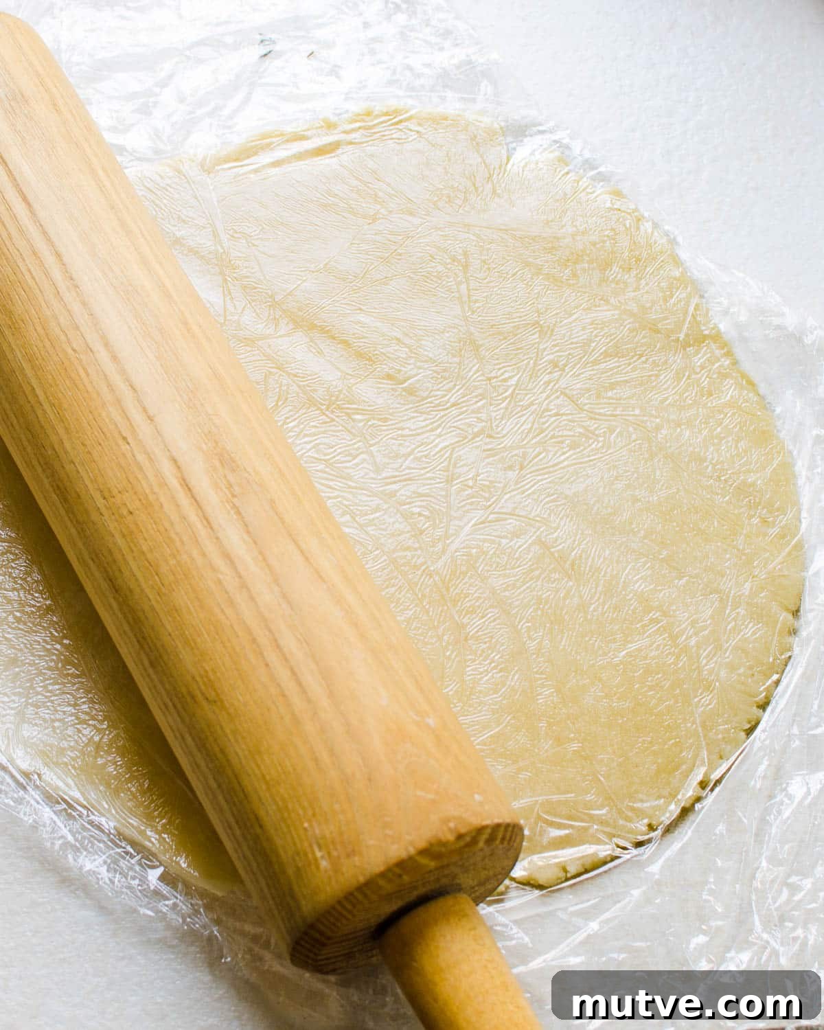 Rustic Strawberry Rhubarb Galette with Flaky Crust 9 rolling out the pastry.