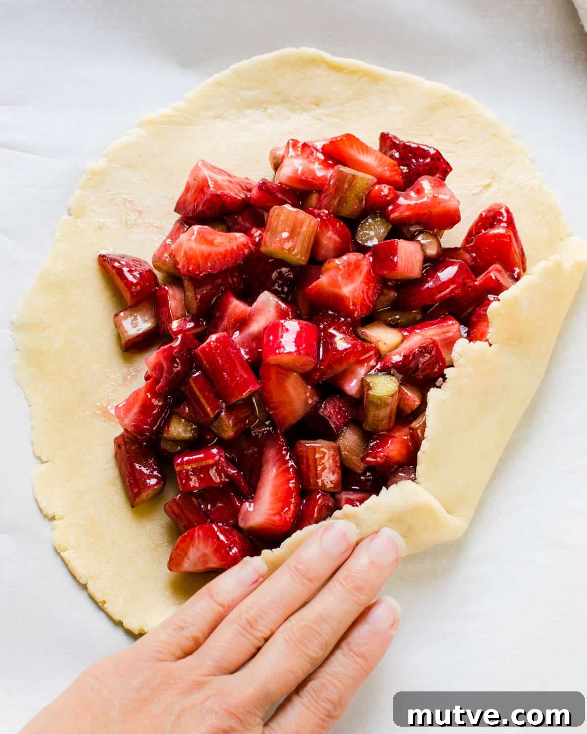 Rustic Strawberry Rhubarb Galette with Flaky Crust 10 Filling the pastry with fruit.