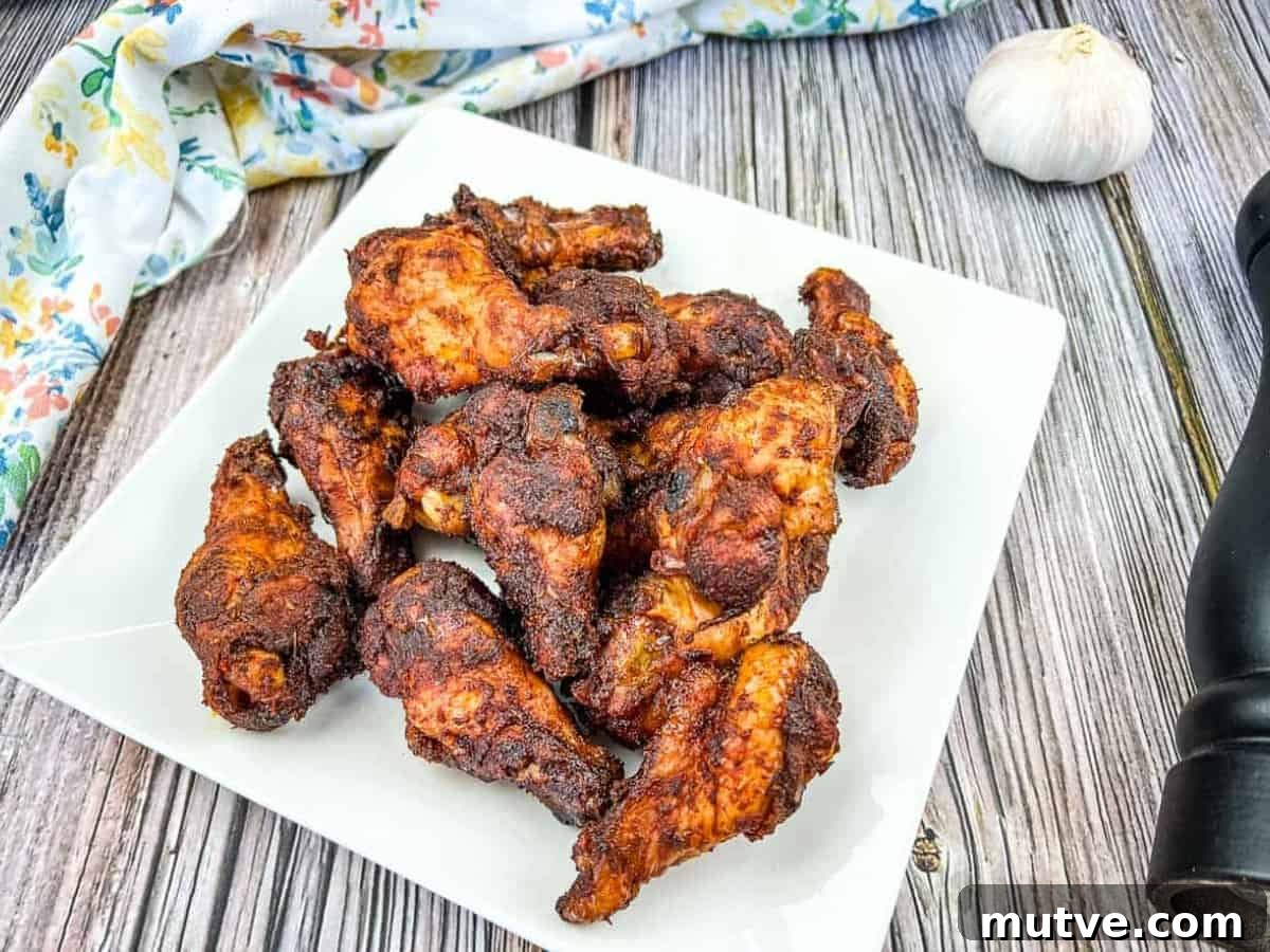 29 Halloween Treats That Beat Your Trick-or-Treat Candy 11 Smoked dry rubbed chicken wings on a white plate with garlic.