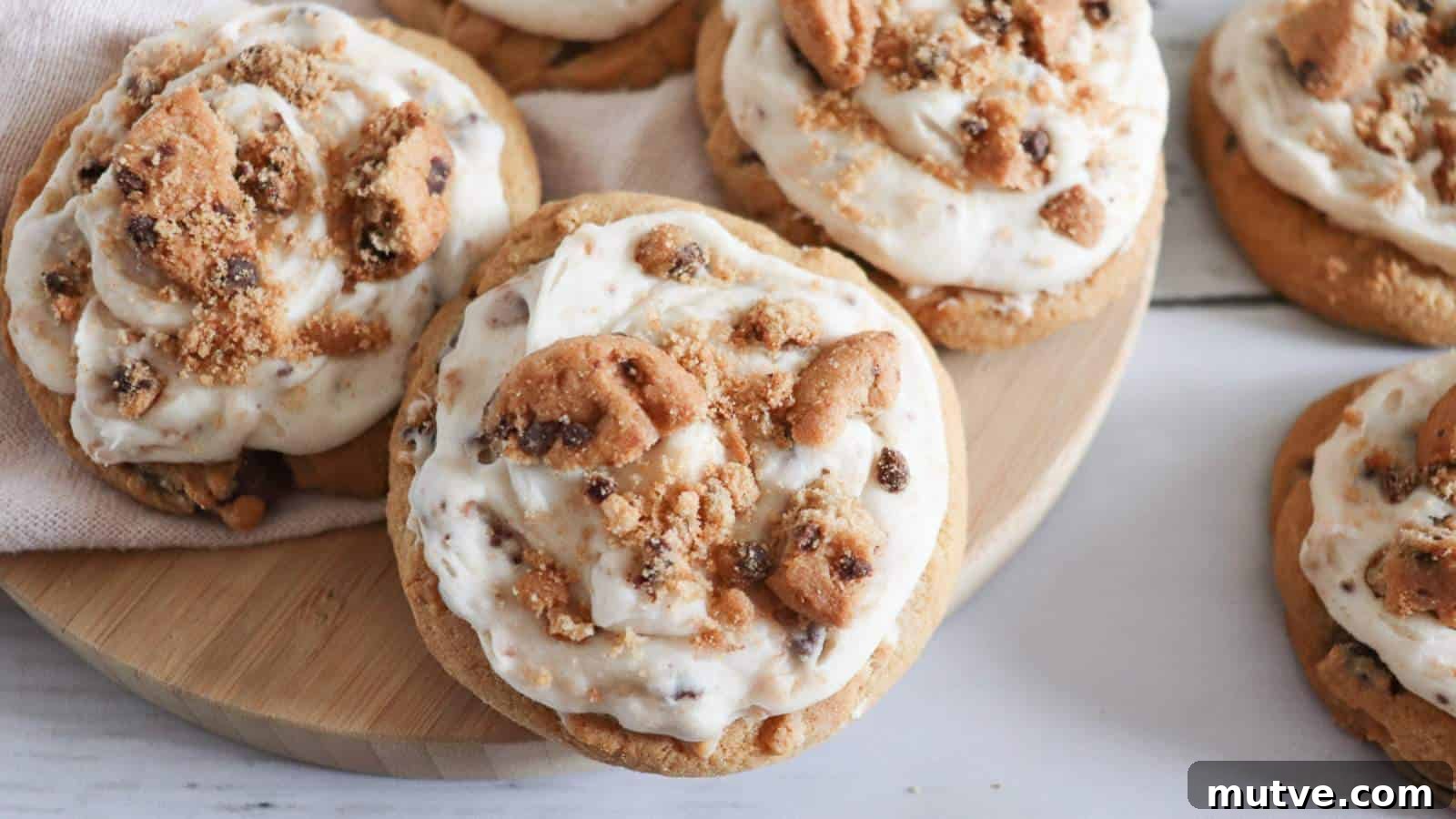 29 Halloween Treats That Beat Your Trick-or-Treat Candy 19 Frosted chocolate chip cookie cookies on a wooden cutting board.