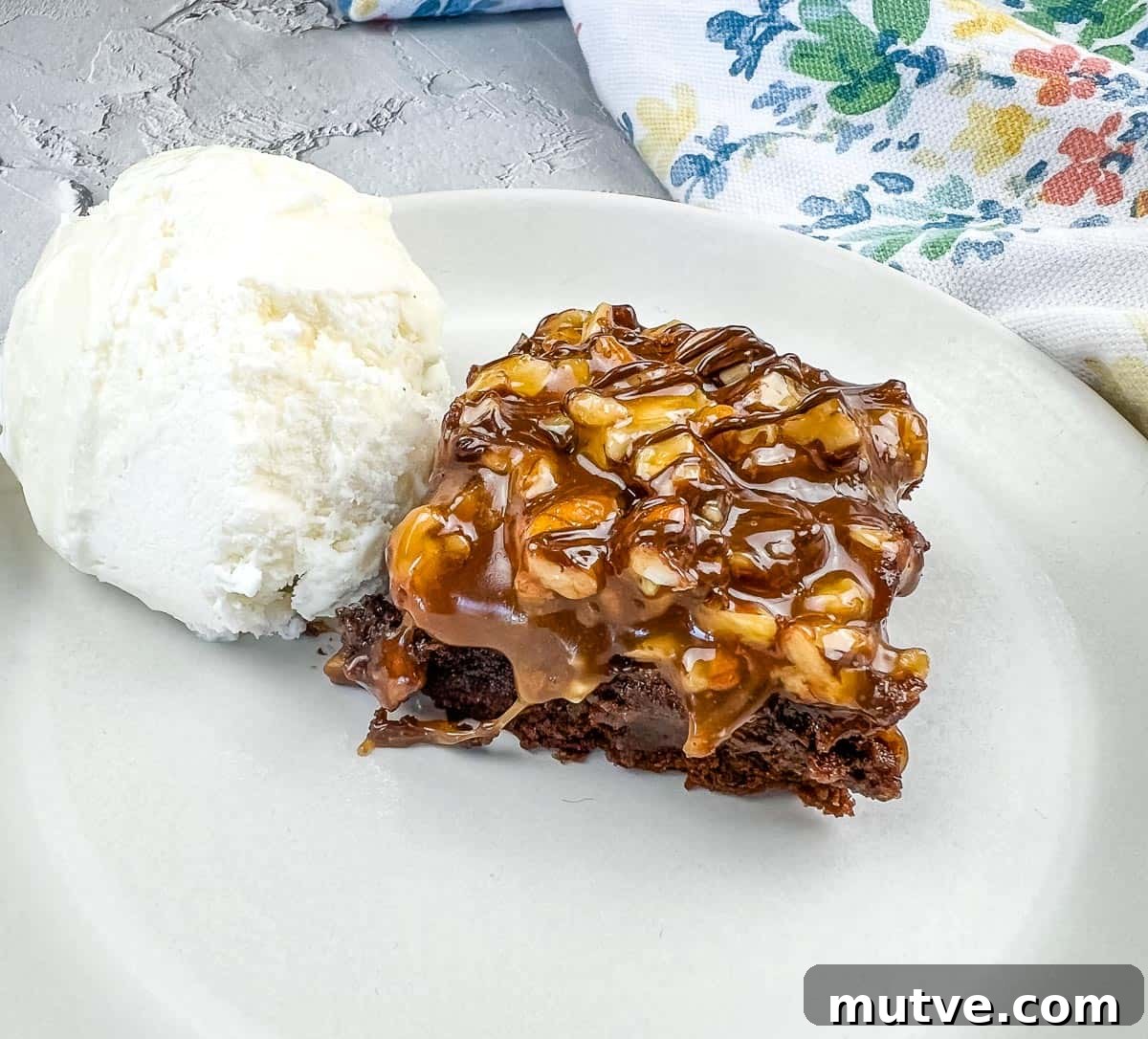 29 Halloween Treats That Beat Your Trick-or-Treat Candy 20 A piece of Turtle Brownie with ice cream on a plate.
