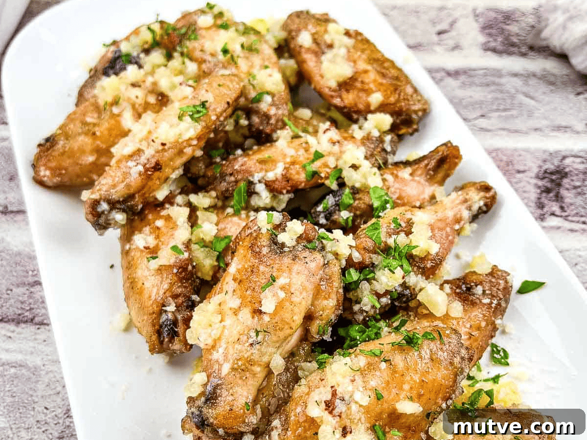 29 Halloween Treats That Beat Your Trick-or-Treat Candy 22 Chicken wings with garlic and Parmesan on a white plate.