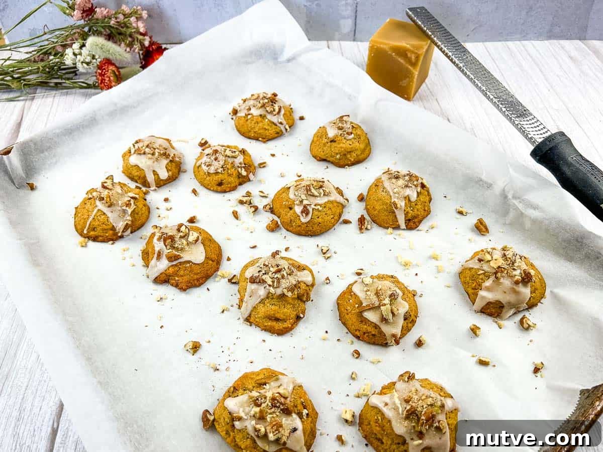 29 Halloween Treats That Beat Your Trick-or-Treat Candy 23 Sweet Potato Cookies on a baking sheet with icing and nuts.
