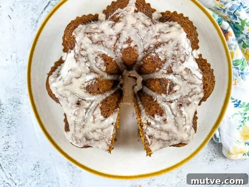 29 Halloween Treats That Beat Your Trick-or-Treat Candy 24 Pumpkin Chocolate Cake on a white circular plate with gold rim.
