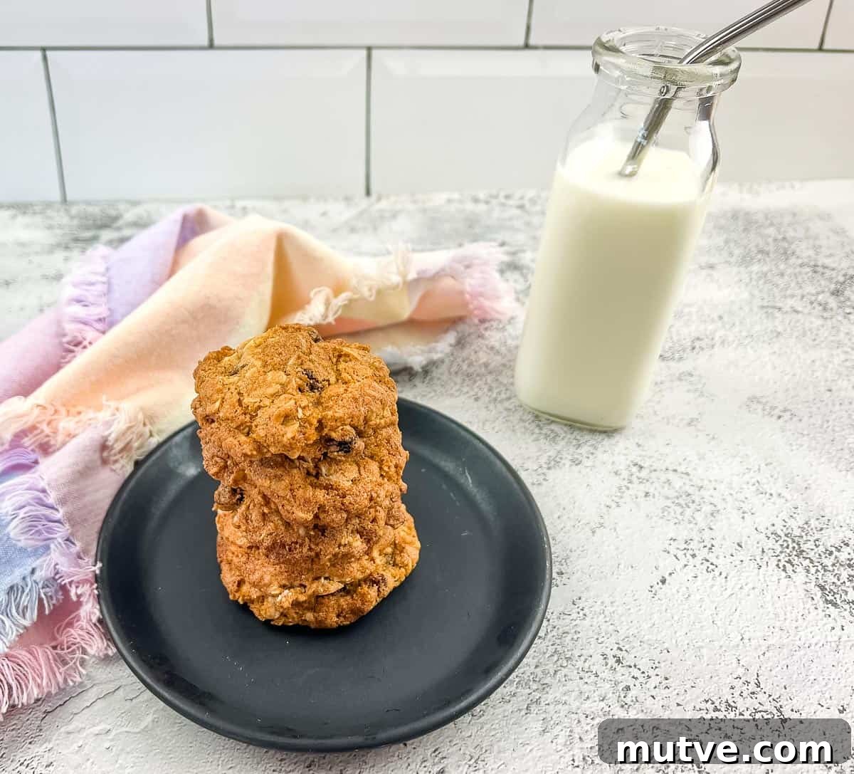 29 Halloween Treats That Beat Your Trick-or-Treat Candy 7 Oatmeal raisin cookies on a plate next to a glass of milk.