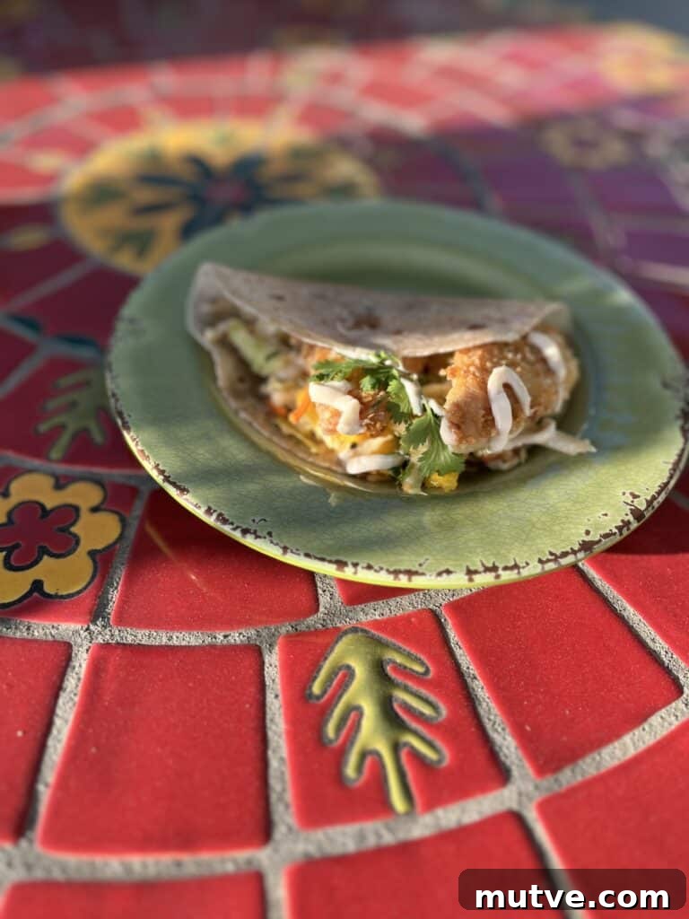 Gluten-Free Fish Tacos on a green plate.