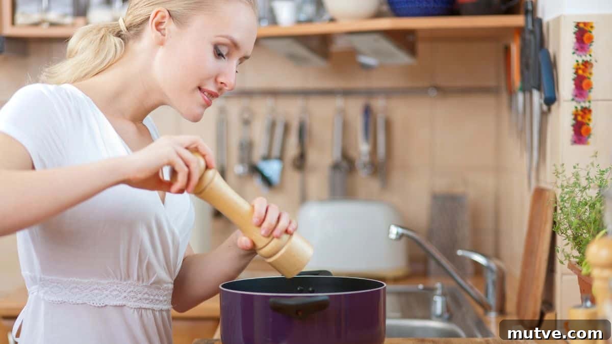 woman cooking with pot and pepper mill