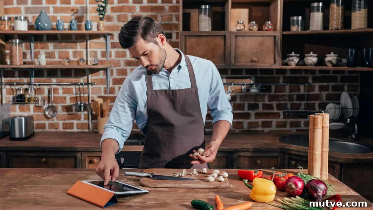 man cooking with tablet