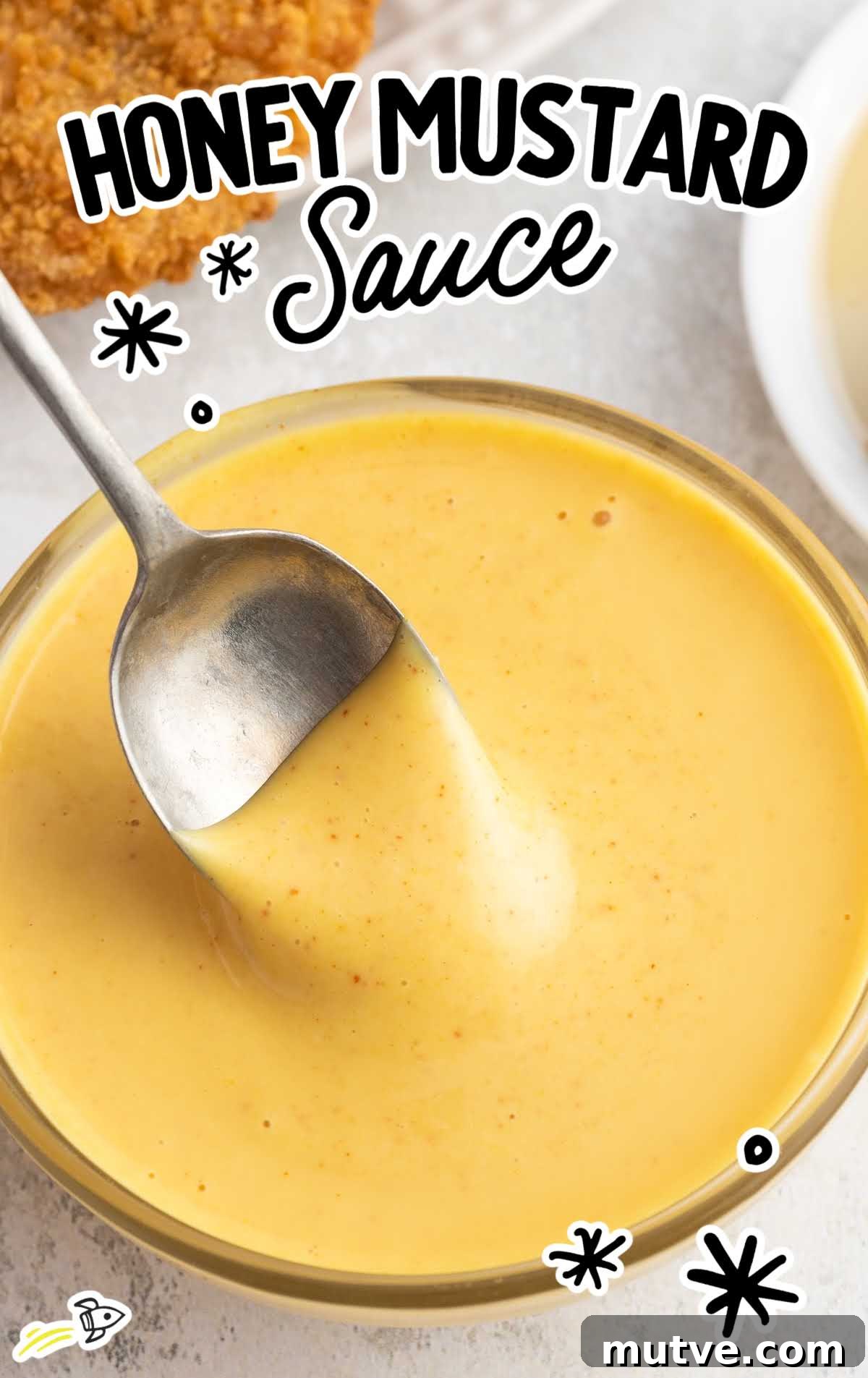 Homemade Honey Mustard Dipping Sauce 2 a close up shot of Honey Mustard Sauce in a bowl with a spoon full of sauce