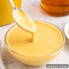 Homemade Honey Mustard Dipping Sauce 7 a bowl of honey mustard sauce with a spoon