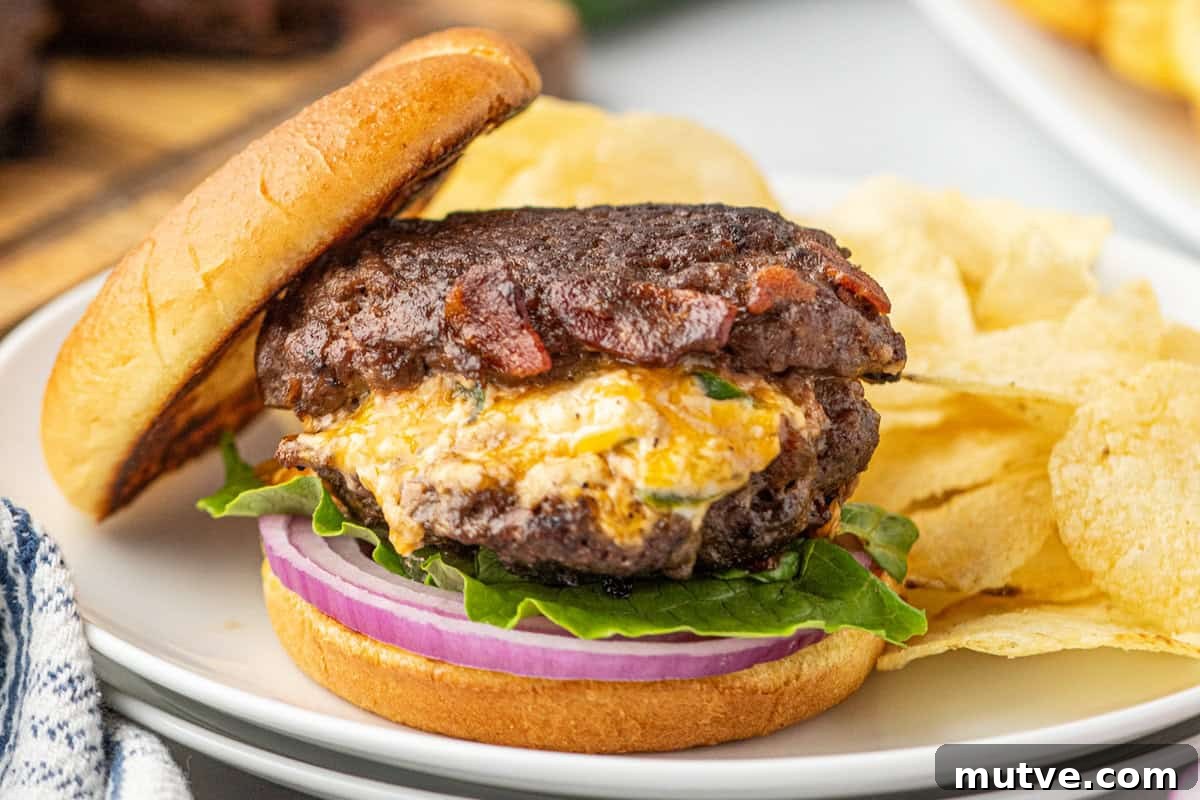 Juicy Jalapeno Popper Stuffed Burger with Bacon and Cream Cheese 11 Jalapeno Stuffed Burger on sliced bun with fixings