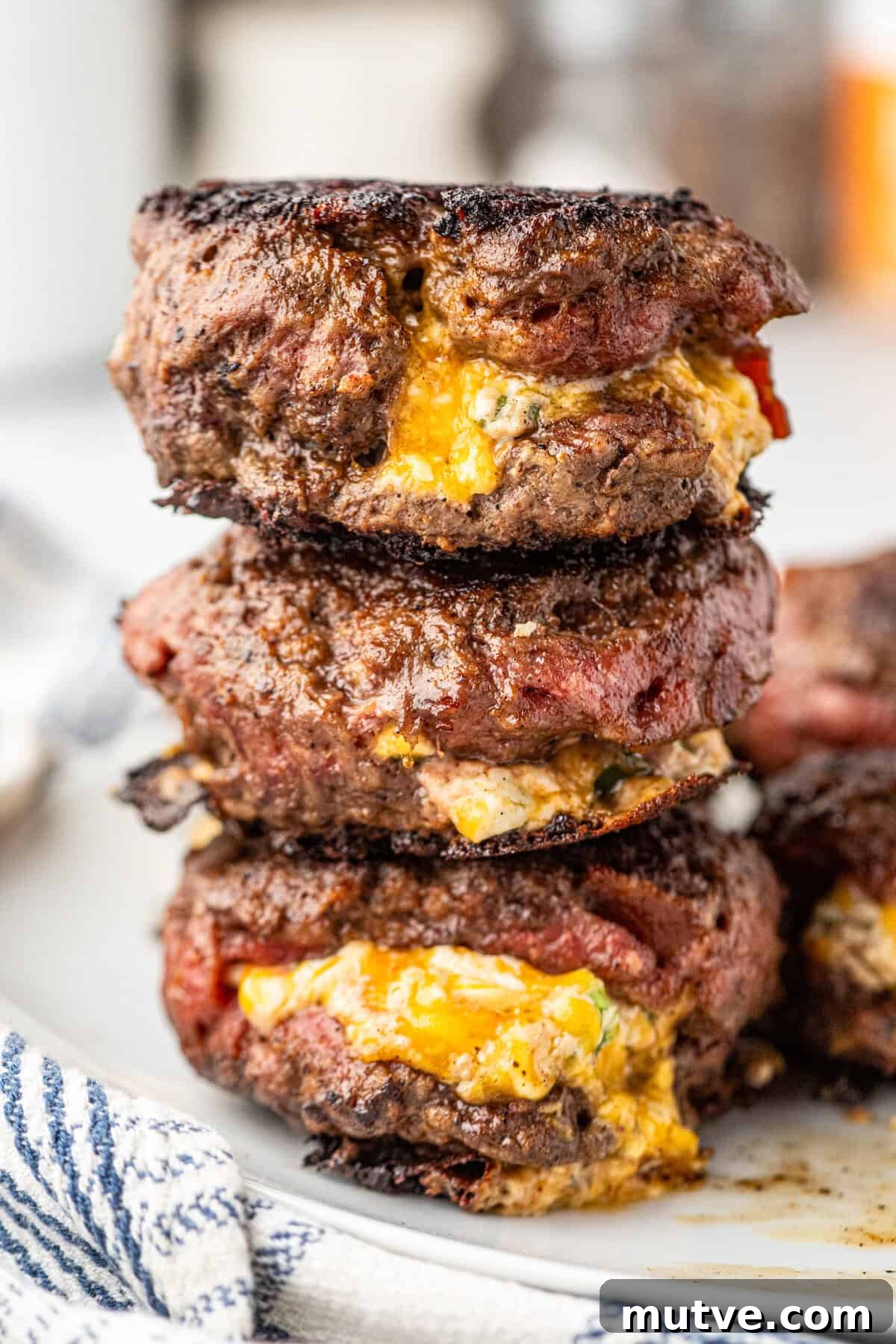 Juicy Jalapeno Popper Stuffed Burger with Bacon and Cream Cheese 10 Jalapeno Popper Stuffed Burgers stacked on serving plate