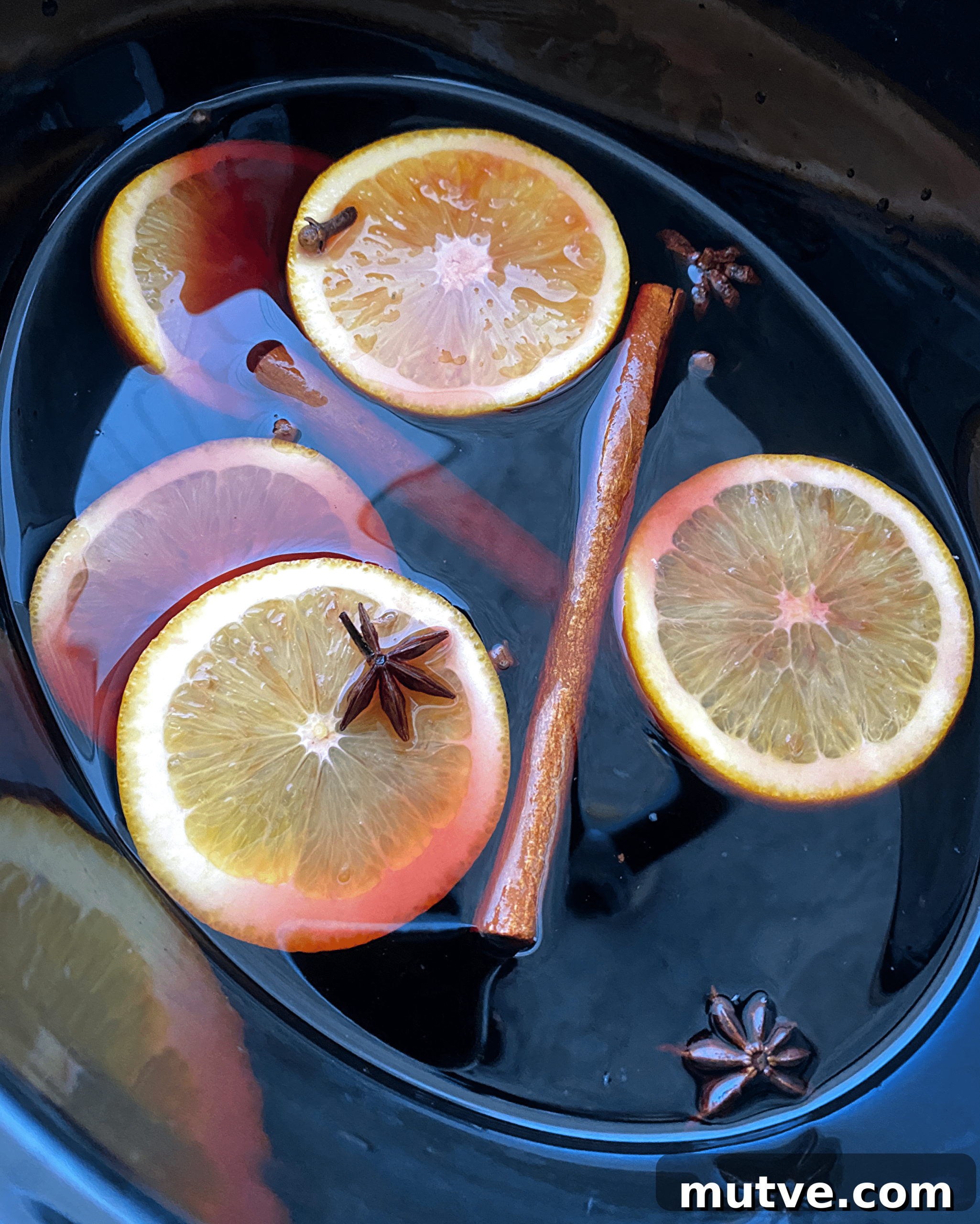Slow Cooker Mulled Wine Recipe: Crockpot Spiced Wine 4 overhead shot of uncooked mulled wine in a black slow cooker