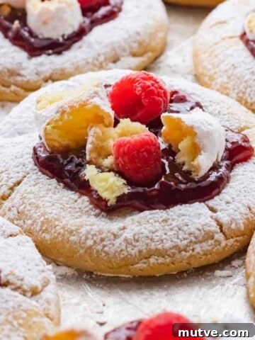 Baked raspberry donut cookies on metal pan.