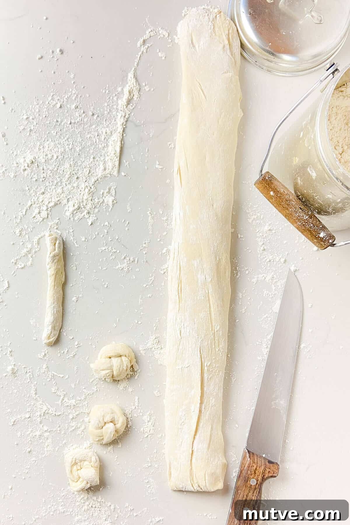 Homemade Garlic Knots Recipe with Herb Butter 12 Forming the knots into shape.