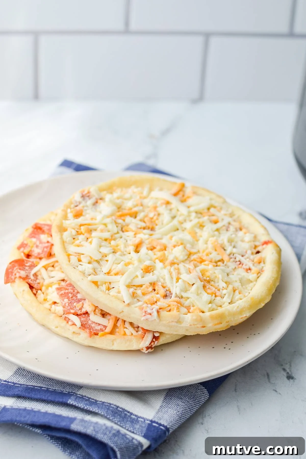 Crispy Frozen Mini Pizzas in the Air Fryer 3 Two mini pizzas from frozen on a plate.