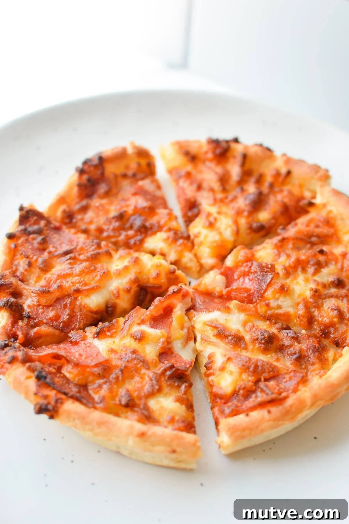 Crispy Frozen Mini Pizzas in the Air Fryer 6 A cooked mini pizza, cut into 6 pieces.