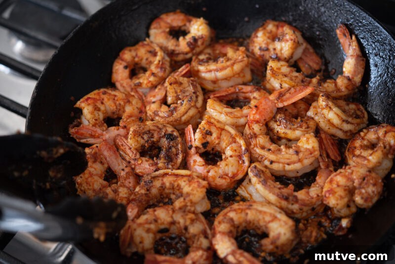 Quick Chili Garlic Shrimp with Chili Crisp Recipe 6 Large shrimps are added to chili crips mixture and tossed in a skillet.
