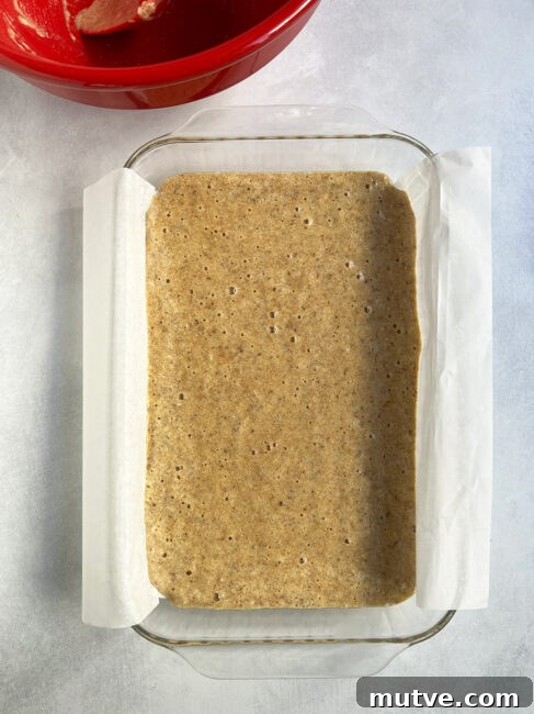 Tishpishti Honey Almond Cake with Citrus Syrup 16 Uncooked batter in the parchment-lined pan.
