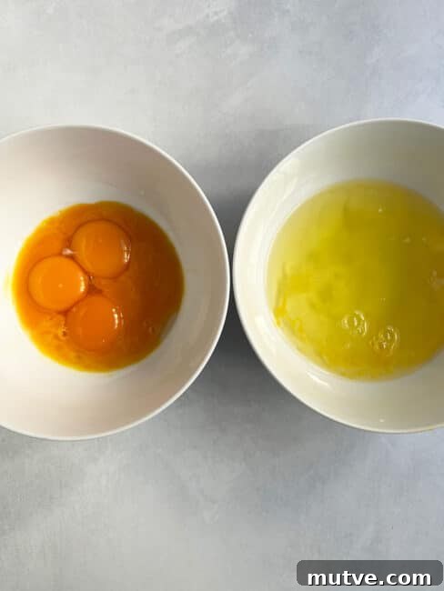 Tishpishti Honey Almond Cake with Citrus Syrup 10 Eggs separated in two white bowls.