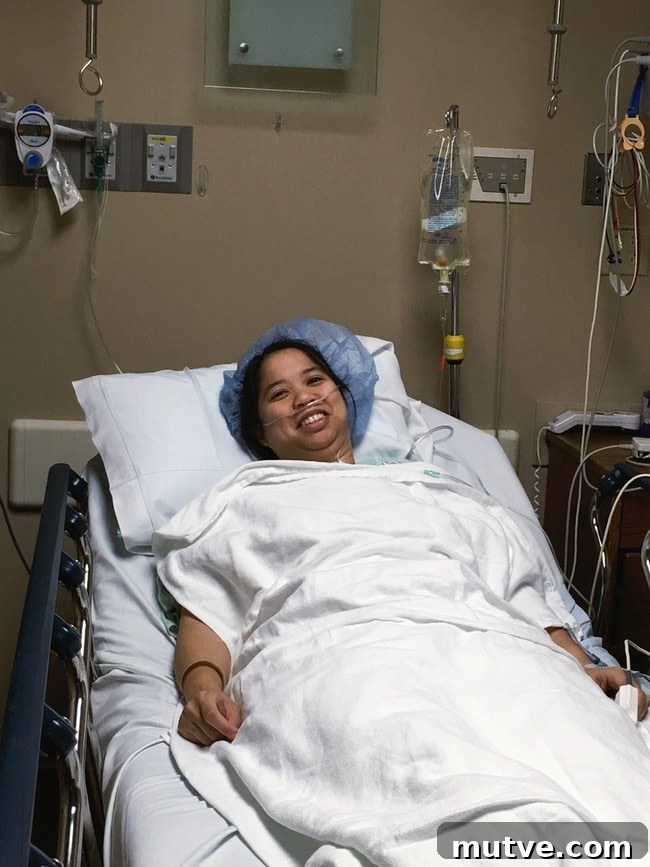 a woman laying in a hospital bed with a hair net on with white blankets